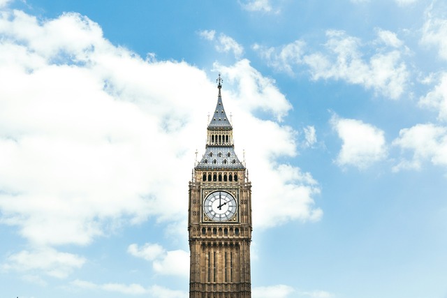 A daytime view of the top half of Big Ben clock tower in London framed by a brilliant blue and white cloud-strewn sky. Image at LondonOfficeSpace.com.