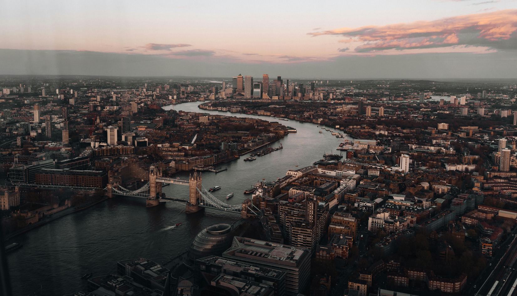 A modern glass-fronted office building in the City of London under a cloudy sky, reflecting the dynamic London office market in 2025. Image at LondonOfficespace.com.